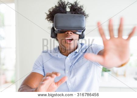 African amaerican man having fun playing with virtual reality glasses