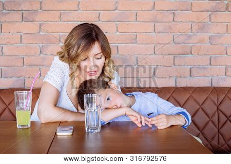 Young Mom Is Looking Angry With Her Boy, Telling Him Something, He Looks Like He Doesn Not Care, Not