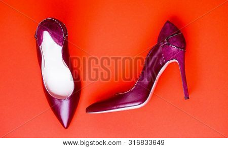Fashionable Women Shoes Isolated On Red Background. Stylish Classic Women Leather Shoe. Maroon High 