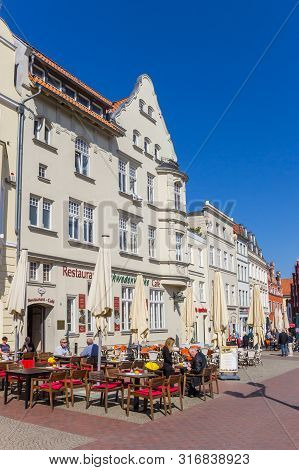 Wismar, Germany - April 19, 2019: People Enjoying The Sun At The Market Square Of Wismar, Germany
