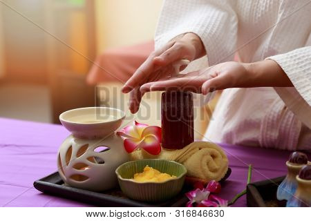 Asian Woman Testing Salt Scrub For Massage At Spa.