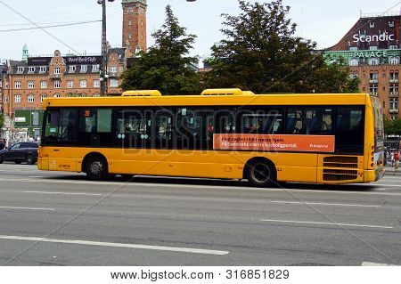 Copenhagen, Denmark - July 20, 2019:  Yellow Public Transport Bus In The City Of Copenhagen.