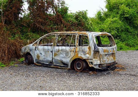 Store Heddinge, Denmark - July 19, 2019: Burned Out Volkswagen Touran By The Side Of The Road. Nobod