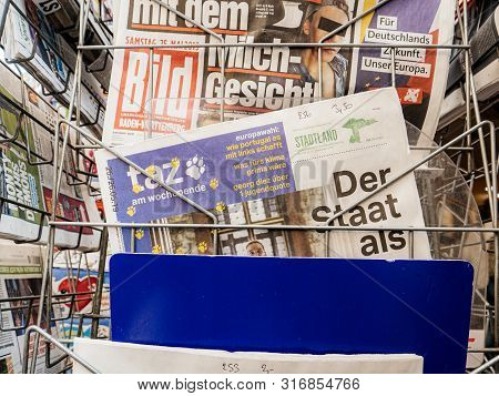 Strasbourg, France - May 25, 2019: Man Hand Pov Reading Taz At Press Kiosk Newspaper Featuring Eu Ne