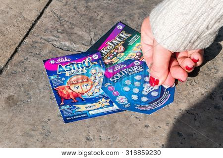 Orange, France - June 4, 2019: Woman Hand Scratching A French Lottery Scratch Card With Nail.