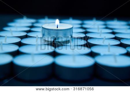 Business Idea, Individuality And Creativity. Success And Motivation. One Candle Is Lit Among A Group
