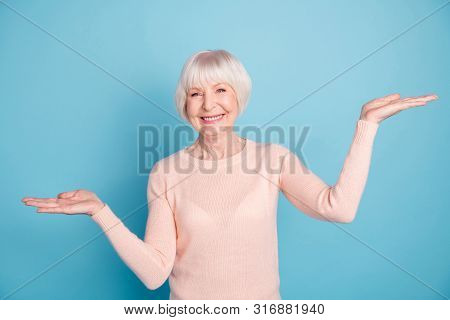 Portrait Of Lovely Promoter Holding Her Hands Palms With Beaming Smile Wearing Pastel Jumper Isolate