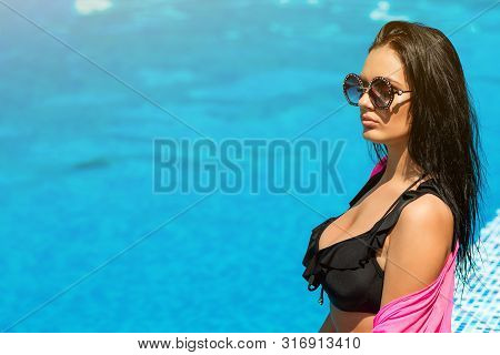 Fashionable Sexy Hot Beautiful Girl In Black Bikini Relaxing Near Pool. Women Summer Fashion. Sensua