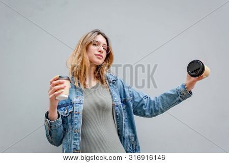 Blonde Girl With Paper Cups Of Coffee On Grey