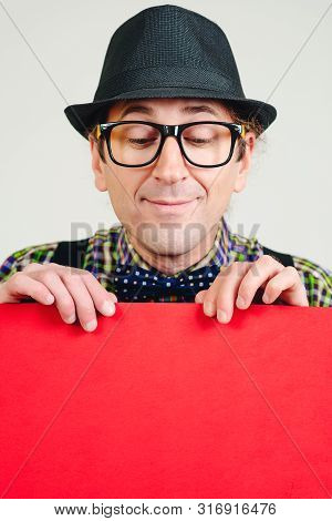 Pozitive Nerd Man Holds Place Announcement On Banner. Man Shows Space For Your Design. Guy Wears Spe