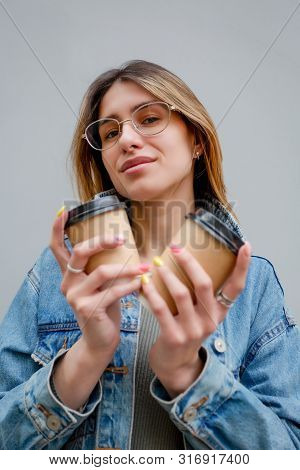 Blonde Girl With Paper Cups Of Coffee On Grey