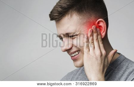Ear Infection. Suffering Man Touching His Inflamed Head, Empty Space