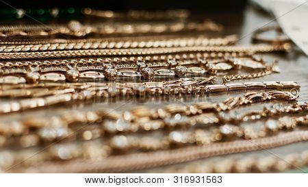 Luxury Gold Jewelry Chains, Bracelets Background, Selective Focus. Stylish Beautiful Bijouterie Hang