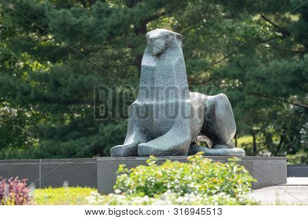 Arlington, Va - August 8, 2019: A Bronze Lion Statue Looks Over The City Of Washington Dc From The N