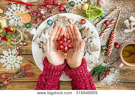 Anonymous Person Holding Star Over Christmas Table
Top View Of Crop Person In Sweater Carrying Chris