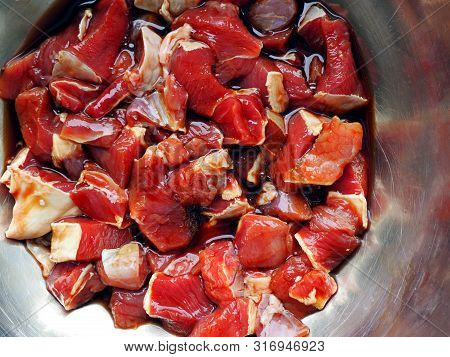 Raw Beef Chopped In Metallic Bowl. Cooking Engredients For Braised Beef Meat Stew. Close Up View