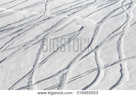 Snowy Off-piste Ski Slope With Trace From Skis And Snowboards At Sunny Winter Day