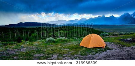 Tent on a ridge with approaching stom.