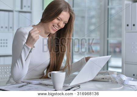 Portrait Of Young Woman Working At Office