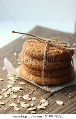 Homemade Oatmeal Cookies On An Old Wooden Table, Rustic Style. Oatmeal And Cinnamon Sticks. Copy Spa