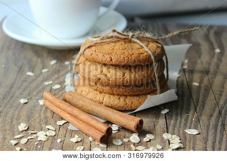 Homemade Oatmeal Cookies On An Old Wooden Table, Rustic Style. Oatmeal And Cinnamon Sticks. Copy Spa