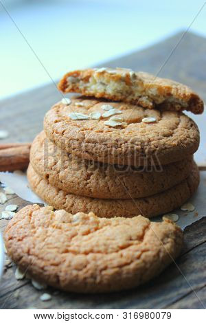 Homemade Oatmeal Cookies On An Old Wooden Table, Rustic Style. Oatmeal And Cinnamon Sticks. Copy Spa