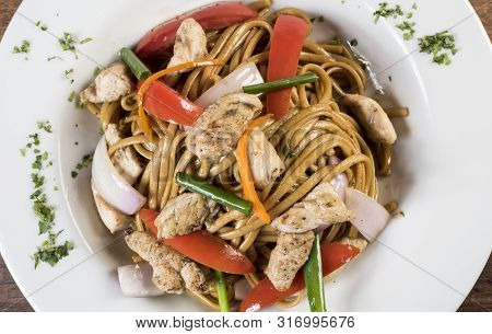 Tallarin Saltado Traditional Peruvian Meal. Peru. On A White Plate
