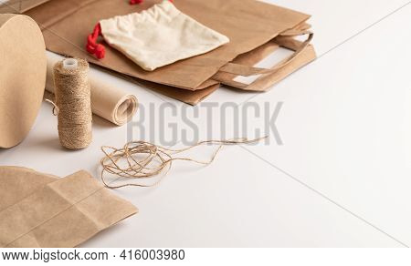 Eco-friendly Packaging Materials. Paper Bag, Cloth Bag, Jute Rope, Cardboard Round Gift Box On A Whi
