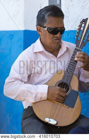 Trujilo, Peru, January 25,2015: Blind Peruvian Man Playing Guitar Outside In The Street Of Trujillo,