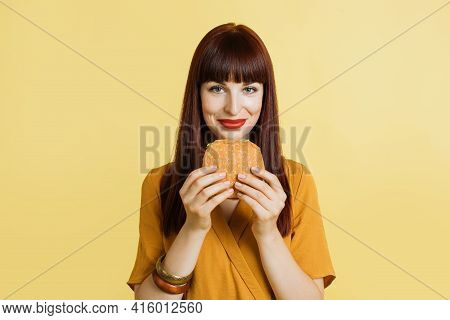Junk And Fast Food Concept. Cheerful Young Pretty Brught Woman In Yellow Shirt And Red Lipstick, Hol