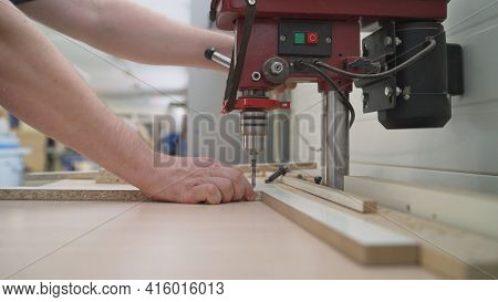 The Process Of Manufacturing Cabinet Furniture From Chipboard On A Modern Automatic Drilling And Mil