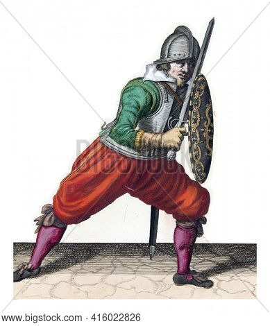 The exercise with shield and spear: the soldier in a defensive position with one foot forward and with his rapier and shield on the knee in front of the body, vintage engraving.