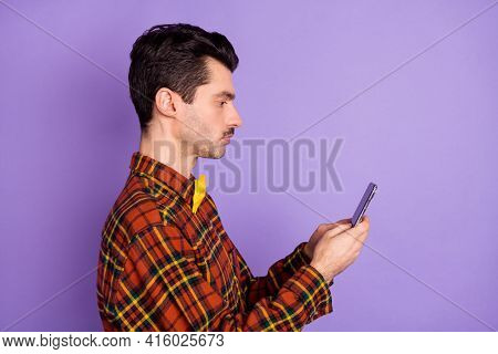 Profile Photo Of Serious Guy Hold Telephone Look Screen Wear Bow Tie Plaid Shirt Isolated Violet Bac