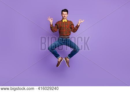 Photo Of Peaceful Guy Jump Lotus Pose Meditate Wear Spectacles Bow Tie Plaid Shirt Jeans Isolated Pu