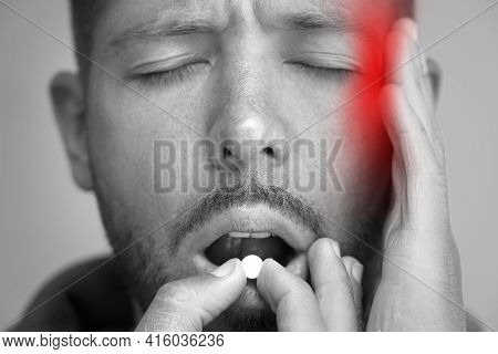 Man Suffering From Headache And Taking Painkillers To Relieve Pain. Pill Or Tablet From Migraine, Te