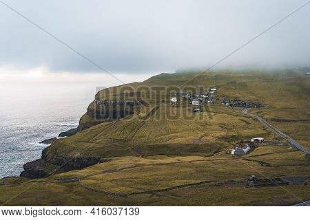 Bour Village Grass-covered Picturesque Houses At The Faroese Coastline In The Village Bour With View