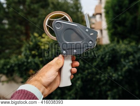 Point Of View Male Hand Holding Against Green Background New Tape Dispenser With Scotch Tape Adhesiv