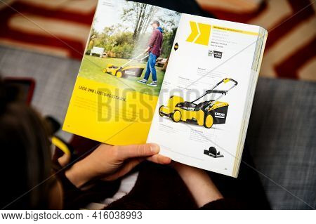 Paris, France - Mar 2, 2021: Curious Woman Reading Latest Advertising Catalogue Of Karcher German Fa