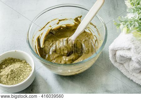 Henna Dry Powder, Glass Bowl With Henna Rehydrated, White Terry Towel On A Marble Mat. Home Hair Col