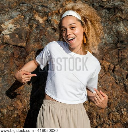 Happy woman in white crop top outdoor photoshoot