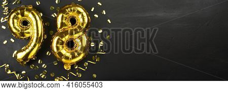 Golden Foil Balloon Number Ninety Eight. Birthday Or Anniversary Card With The Inscription 98. Black