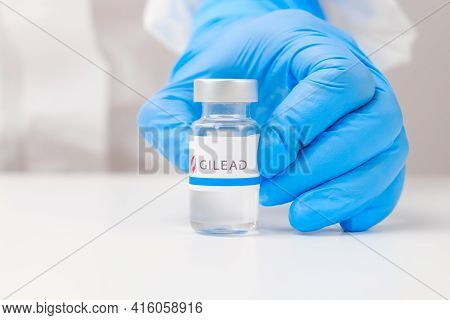 Gilead Vial Or Bottle For Injection With Pharmaceuticals Or Drugs In Scientist Hands In Rubber Glove