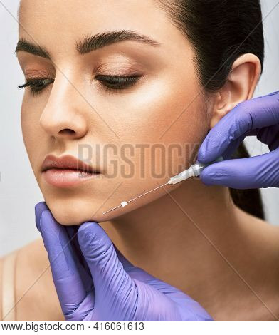 Mesothreads Facial. Face Contour Lifting Procedure, A Needle With Mesothreads Near A Female Face, Cl