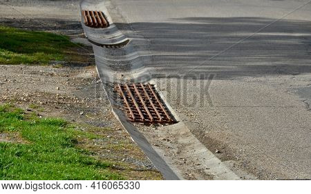 At The Edge Of The Road Is A Concrete Trough For Collecting Rainwater. For Cars And Cyclists To Cros