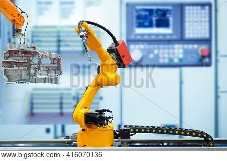 Moving Welding Robot And Robot Gripping Working With Engine Parts Of Motorbike On Blurred Smart Fact