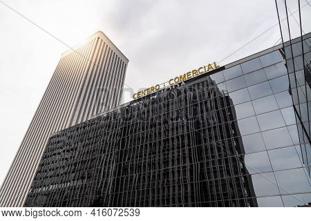 Madrid, Spain - March 28, 2021: Moda Shopping Mall And Torre Picasso Skyscraper Against Sky With Sun