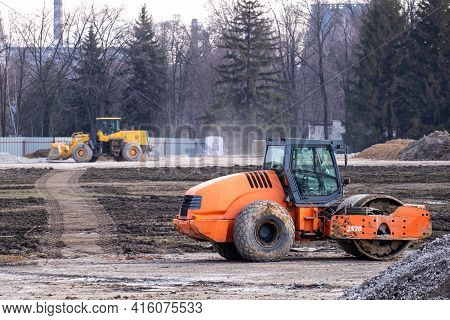Road Roller Rink Workig To Construction Of A New Highway. Heavy Industrial Machinery Build A Road.