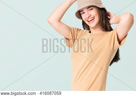 Woman in beige t-shirt dress and bucket hat casual wear apparel
