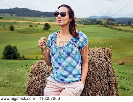 Beautiful woman relaxing in nature. Happy people in nature. Woman relaxing in nature meadow. Nature lifestyle. Happiness. Lifestyle. Concept of nature lifestyle. Happy people. Happy young woman in nature. Happiness concept. Young people in nature. Nature