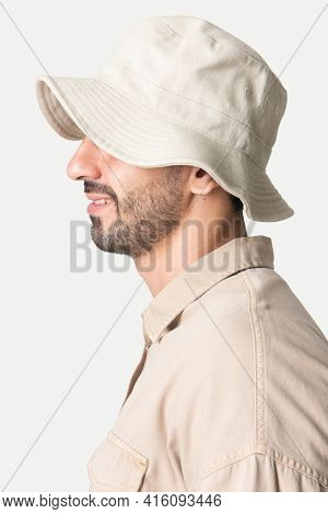 Man in a beige bucket hat and shirt fashion studio shoot